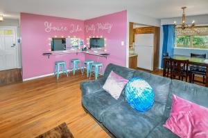 a living room with a couch and a pink wall at Super Cute Five Bedroom Home in Denver Perfect For Girls Trips in Denver