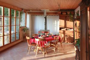 a dining room with a table and chairs in a kitchen at VALRELEY, chambres et table d'hôtes eco-friendly avec bain nordique au sud du massif du Jura in Champagne-en-Valromey