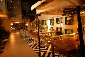 a restaurant with wooden tables and chairs and lights at The Bougainvillea Bed & Breakfast in Amritsar