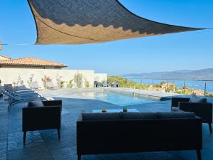 a view of a pool with chairs and a couch at Torriciola location Casa Rocca in Propriano