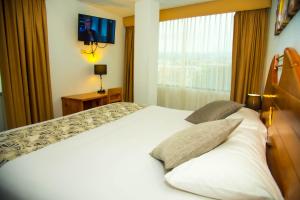 Postel nebo postele na pokoji v ubytování Hotel la Giralda