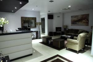 a living room with a couch and a table at Hotel Katia in Chaves