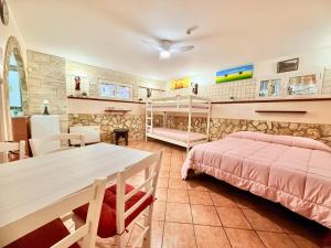 a bedroom with a bed and a desk and a table at OPEN SPACE Littoria in Latina