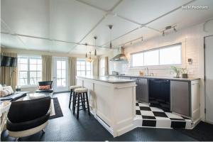 a kitchen with a counter and a living room at Boat House Loft in Port Rexton