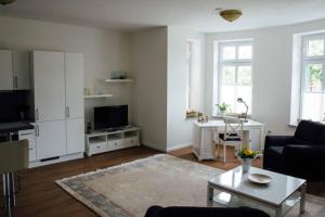a living room with a couch and a table at Villa Schönfeld Wohnung 1 in Papenburg