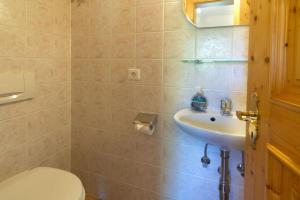 a bathroom with a toilet and a sink at Abendruh -566- in Krün