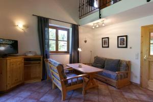 a living room with a couch and a table at Abendruh -566- in Krün