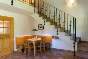 a dining room with a table and a staircase at Abendruh -566- in Krün
