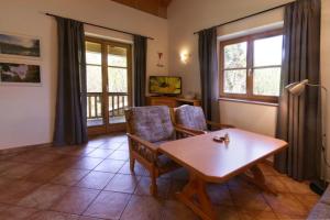 a living room with a wooden table and chairs at Abendruh -566- in Krün