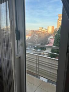 a window with a view of a city at Studio Charlie Aviv Park in Mirijevo