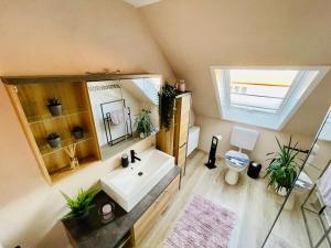 a bathroom with a sink and a mirror at Fewo Elke in Barsinghausen