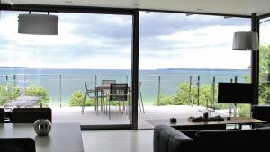 a living room with a view of the ocean at Triton Suite in Eckernförde