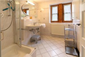 a bathroom with a tub and a sink and a shower at Edith -559- in Mittenwald