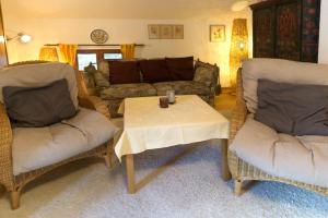 a living room with two chairs and a table at Edith -559- in Mittenwald