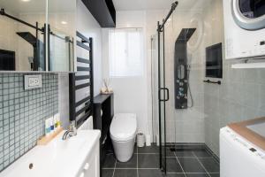 a bathroom with a toilet and a shower and a sink at Aotearoa House Yomitan, BBQ, Pizza Oven in Yomitan +79 photos