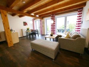 a living room with a couch and a table at Ferienwohnung 6 in Ochsenhausen +11 photos