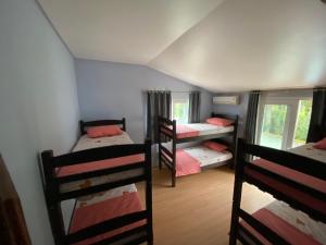 a room with four bunk beds in a room at Imana Hostel in Florianópolis