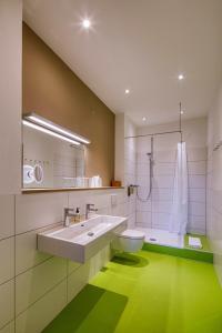 a bathroom with a large sink and a toilet at XXL-Apartment 2015 in Walsheim