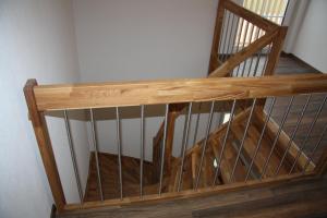 a wooden stair case with a wooden railing at Ferienwohnung Balkon in Bräunlingen