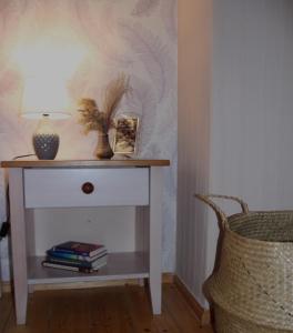 a white table with a lamp on it next to a chair at Ferienwohnung Felicitas Wilthen in Wilthen