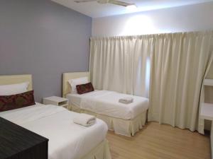 Postel nebo postele na pokoji v ubytování Alami Garden Hotel