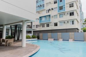 a swimming pool in front of a building at SuiteEscape in Iloilo City