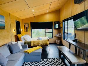 a living room with a couch and a bed at The Sanctuary in Ohakune