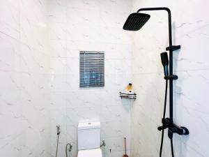a light in a bathroom with a toilet at Fabulous 2 Bedroom Flat in Iju Junction +8 photos