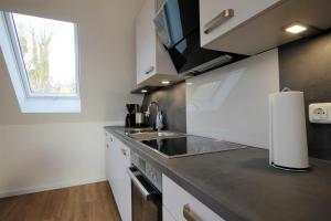 Kuchyň nebo kuchyňský kout v ubytování Ferienwohnung Dons - Strandnahe & moderne Fewo im Ostseebad Grömitz + 13 fotografií