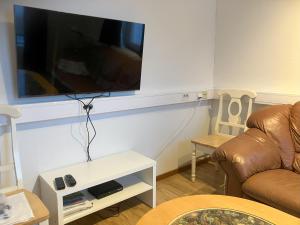 a living room with a couch and a flat screen tv at Målargatan 1 in Piteå