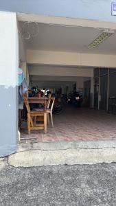 a garage with a table and motorcycles in it at PTts in Bangkok