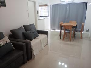a living room with a couch and a table at Dpto zona pelegrini 1 dormitorio cochera opc in Rosario +1 photo