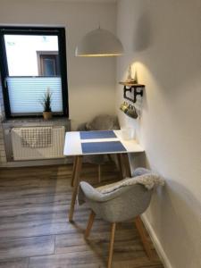 a room with a desk and a chair and a window at Fewo 3 in Nortorf +17 photos