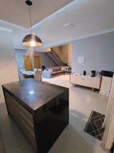 a kitchen and living room with a table and a couch at Family home in Paranapanema