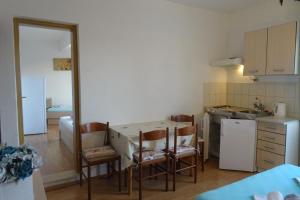 a kitchen with a table and chairs in a room at Apartments with parking space Zivogosce - Blato, Makarska - 23922 in Živogošće +29 photos