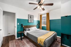 a bedroom with a bed and a ceiling fan at The Coloradical Crashpad! W Fire Pit & Hot Tub in Denver