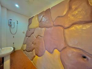 a bathroom with a wall that looks like an elephant at Casaroyal Beachfront Siquijor in Siquijor