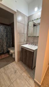 a bathroom with a sink and a toilet and a mirror at Brisas Rumipal dúplex premium Villa Rumipal in Villa Rumipal +84 photos