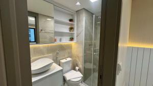 a bathroom with a toilet and a sink and a shower at M N Flats Apartamento Dentro Do Hotel Av Ibirapuera 2534 in Sao Paulo