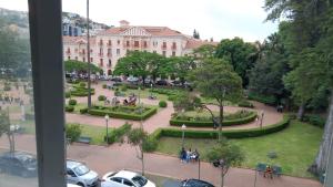 a view of a park with a building in the background at Pousada Sâo Luiz in Poços de Caldas