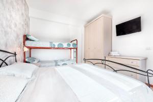 A bed or beds in a room at Jesolo Happy Beach House - Host Solution