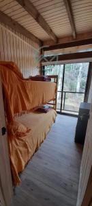 a room with two beds and a large window at Cabañas Cerro de Piedra in Pucón