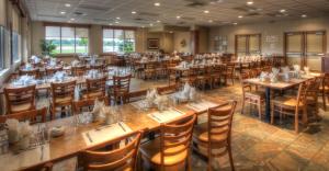a large dining room with tables and chairs at La Porte de la Mauricie in Louiseville