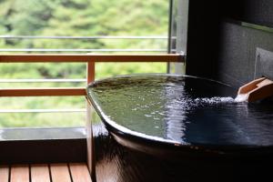 a table in front of a window with water at Arima Onsen Gekkoen Korokan in Kobe