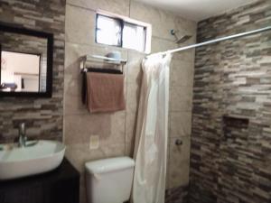 a bathroom with a toilet and a sink at La Terraza-Habitacion 4 Parras de la Fuente in Cedro +8 photos