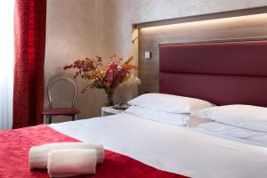 Postel nebo postele na pokoji v ubytování Hotel Gamma