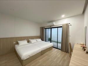 a bedroom with a large bed and a large window at Sri House at Supasarnrangsan in Hat Yai +41 photos