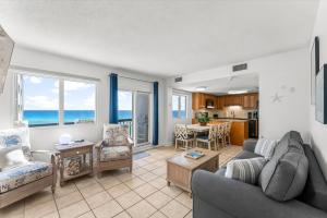 a living room with a couch and a table at Serenity at A-521 in Panama City Beach