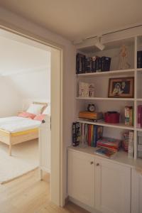a bedroom with a bed and a book shelf at Haus Hummel Ferienwohnung Liese in Lieske