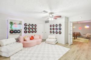 a living room with two couches and a ceiling fan at TX A&M! TAMU! Pet Friendly! 7 Beds, King & Queen! Billiards! Fire Pit Oasis! in College Station